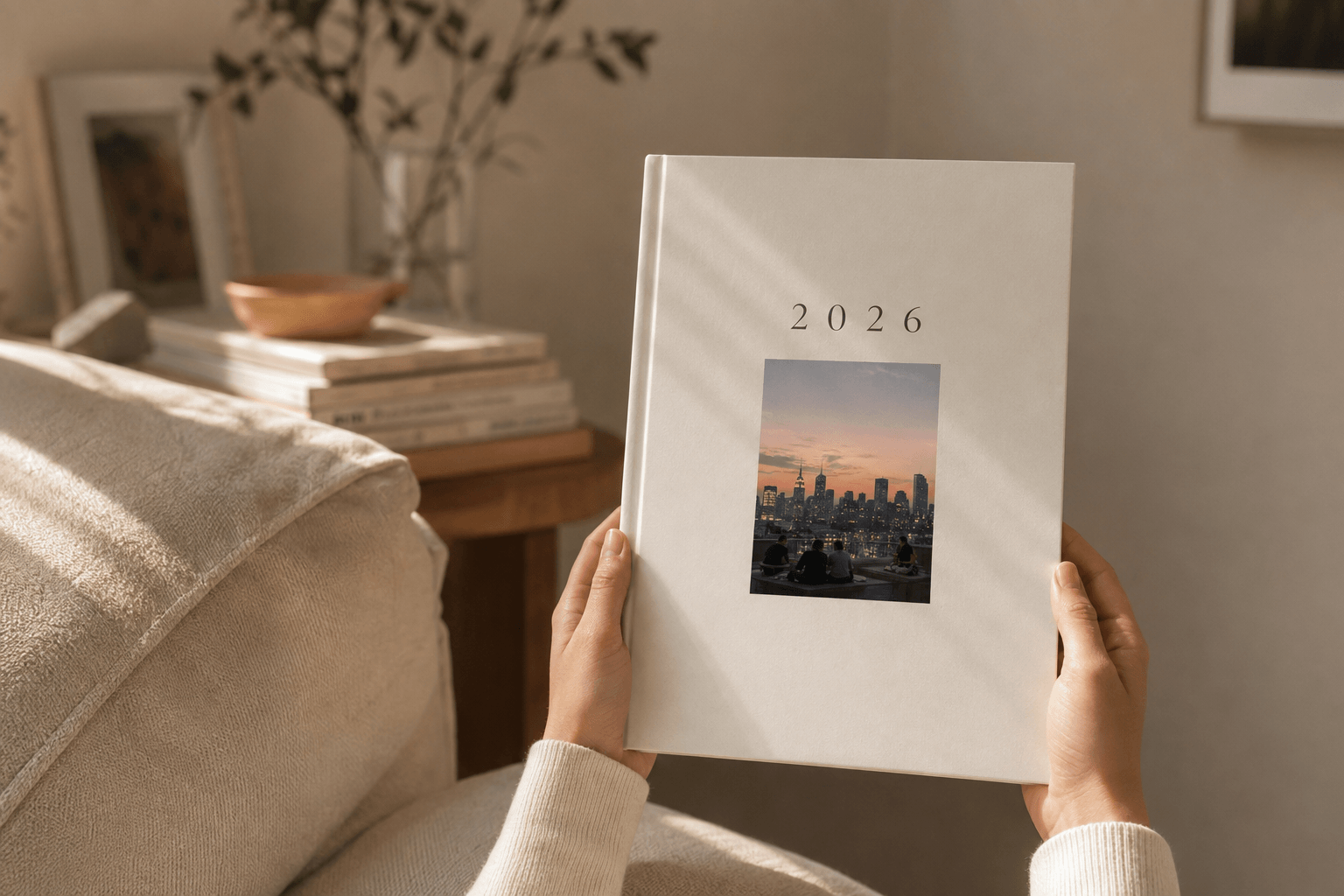 Closed yeerbook cover for 2026 with a rooftop skyline photo inset, held in two hands